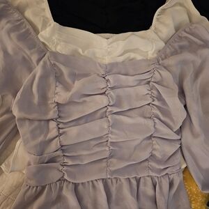 Super cute. black. White and lavendar ruffle shirt off shoulder